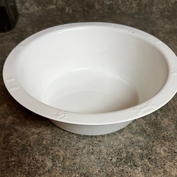 Enamel dog food or water bowl.  Paw prints & bones adorn rim - Picture 1 of 8